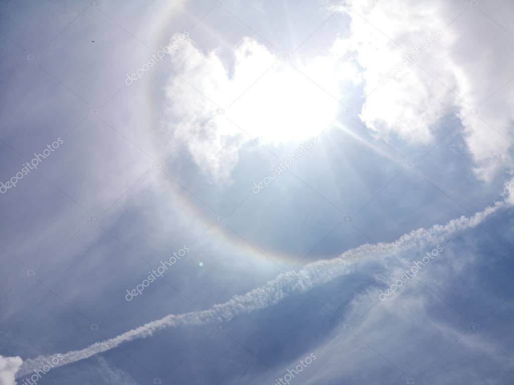 Halo, corona Rainbow refraction Annular white clouds in the blue sky natural background beautiful nature environment