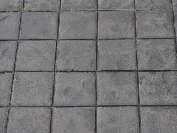 Stamp concrete black color hardener printing patterns on the cement or mortar surface block shape Square pattern material rough texture background