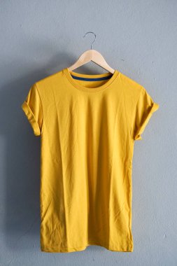 Retro kat sarı Pamuk T-shirt giysi renkli Mock yukarı grunge Beyaz ahşap arka plan kavramı üzerinde şablon perakende elbise dükkanı zemin, boş düz yatıyordu Vintage gri ahşap düz çamaşır reklam