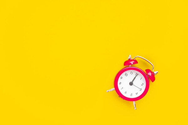 Abstract creative flat lay vintage yellow table top view office background concept red clock on paper color in minimal style, Hot summer holiday time to break workplace at noon for lunch, Retro Hipster back to school vacation 