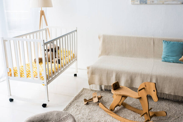 modern interior design of nursery room with rocking horse chair