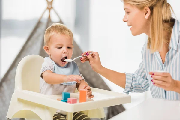 Mother Feeding Son Highchair Baby Food — Stock Photo, Image