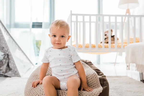 Adorable Toddler Sitting Bean Bag Chair Looking Camera Indoors Nursery — Stock Photo, Image