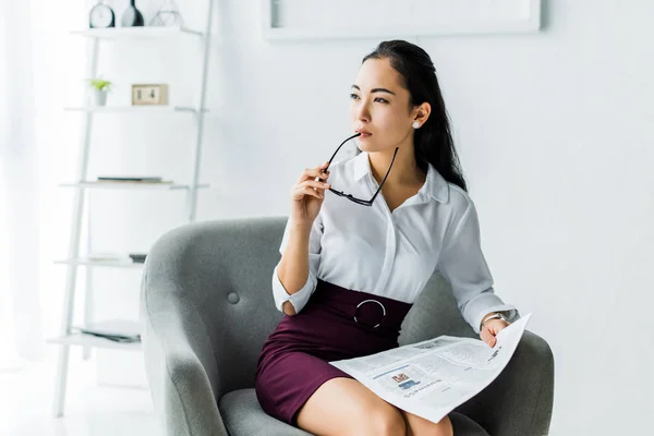 Beautiful Asian Businesswoman Holding Glasses Newspaper While Sitting Armchair Office — Stock Photo, Image