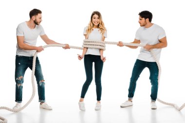 young men holding rope wrapped around smiling young woman showing thumbs up and looking at camera isolated on white clipart