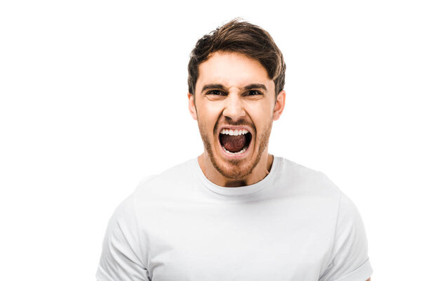 emotional young man screaming and looking at camera isolated on white