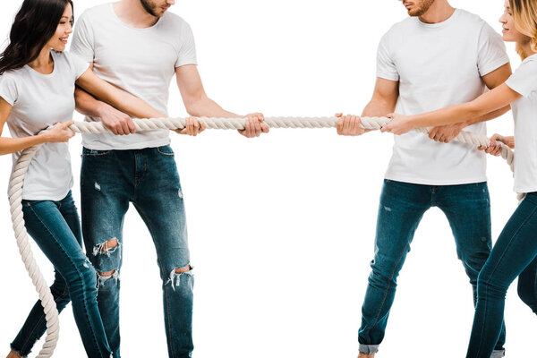 cropped shot of young couples pulling rope and playing tug of war isolated on white