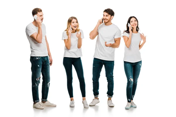 Happy Young Friends Standing Together Talking Smartphones Isolated White — Stock Photo, Image