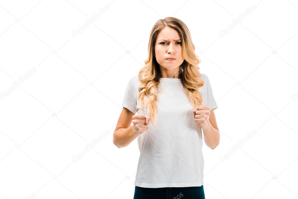 angry girl with clenched fists looking at camera isolated on white