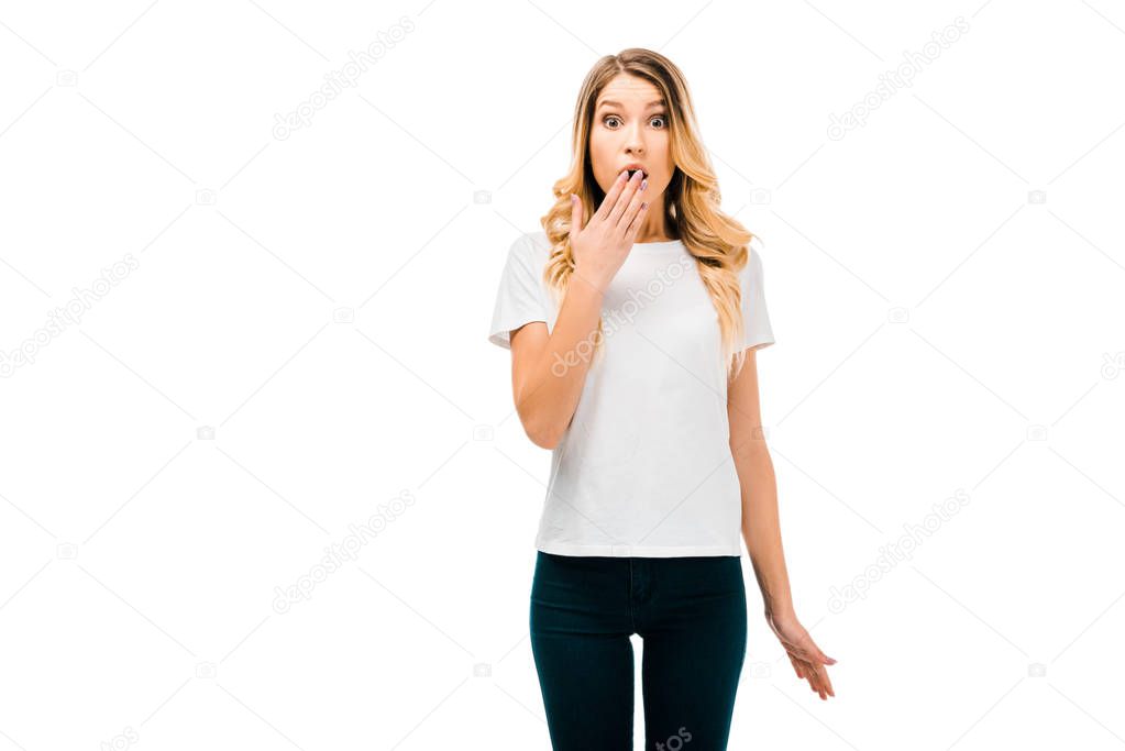 shocked young woman in white t-shirt looking at camera isolated on white