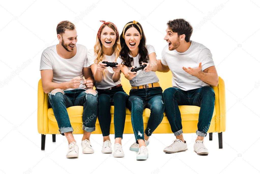 young men looking at excited attractive women playing with joysticks isolated on white