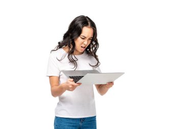 Shoked Genç Asyalı kadın beyaz t-shirt üzerinde beyaz izole dizüstü bilgisayar kullanarak