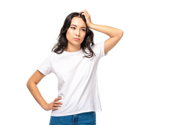 Thoughtful asian woman in white t-shirt hand on head isolated on white 