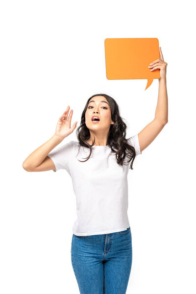 Screaming asian woman in white t-shirt and blue jeans holding speech bubble isolated on white