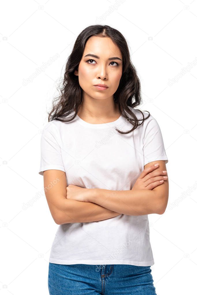 Skeptical dissatisfied asian woman standing with crossed arms isolated on white