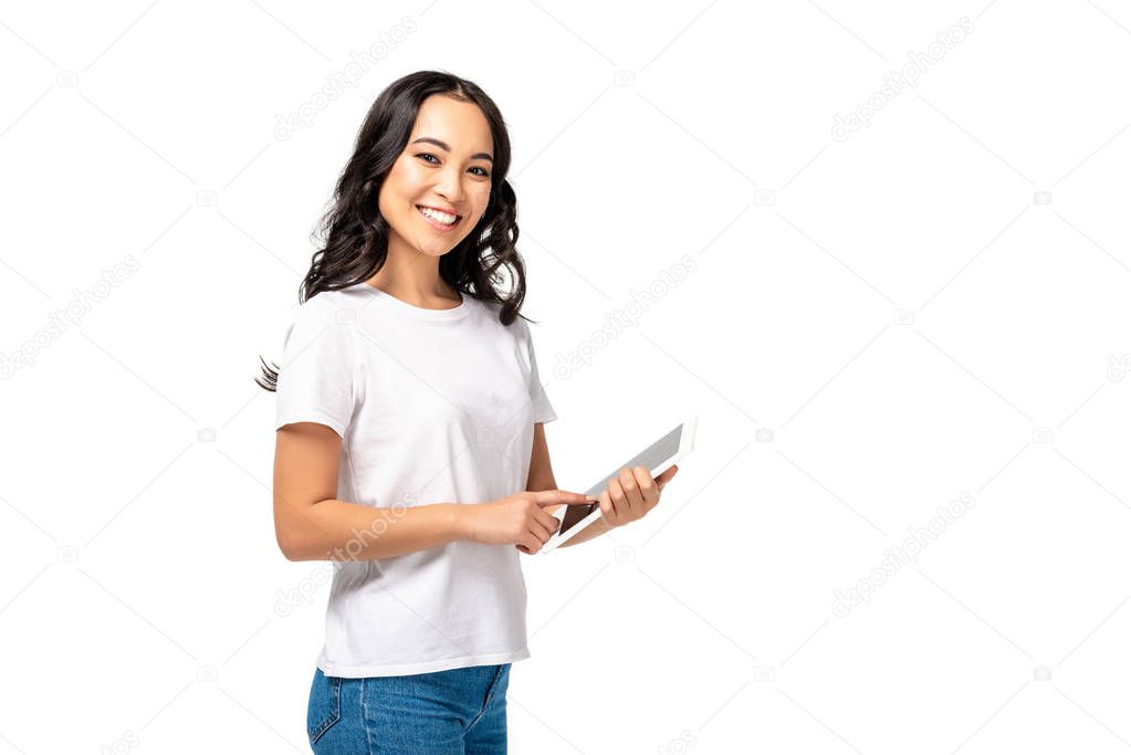 Smiling asian using digital tablet while looking at camera isolated on white