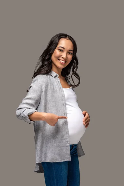 Young Pregnant Asian Woman Pointing Tummy Smiling Isolated Grey — Stock Photo, Image