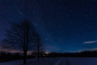 dark sky full of shiny stars in carpathian mountains in winter at night clipart