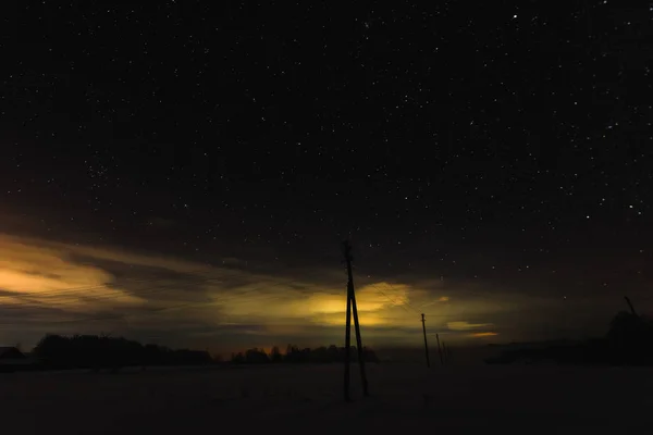 dark sky with yellow illumination in carpathian mountains at night