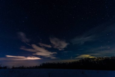 starry dark sky in carpathian mountains at night in winter clipart