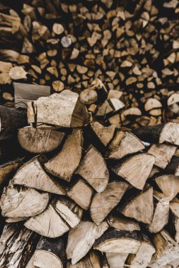 selective focus of  brown textured cut stacked firewood clipart