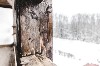 selective focus of textured wooden plank on snowy background clipart