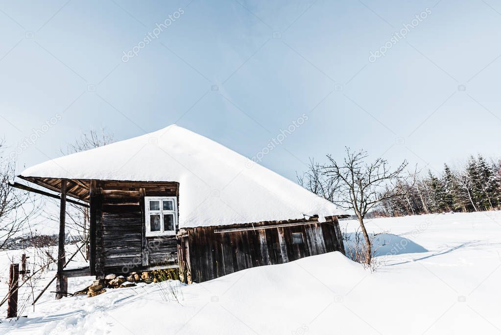 old wooden house with snow in winter carpathian mountains