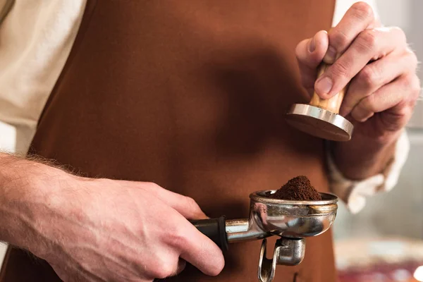 Cropped View Barista Brown Apron Holding Portafilter Ground Coffee Tamper — Stock Photo, Image