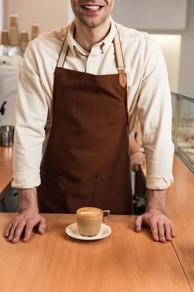 Cropped View Laughing Barista Brown Apron Cup Coffee — Stock Photo, Image