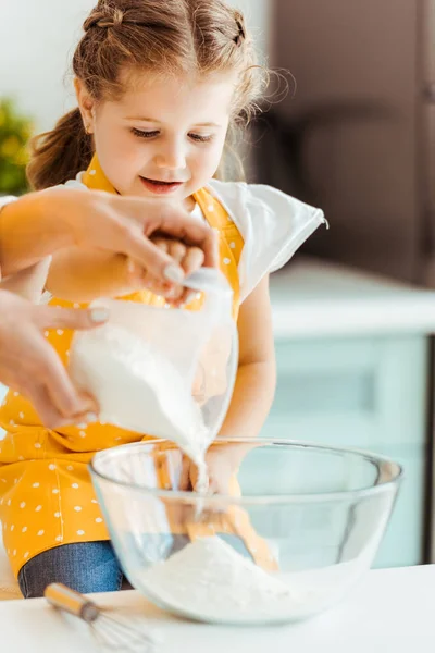 Selective Focus Woman Adding Flour Bowl Excited Daughter Kitchen — Stock Photo, Image