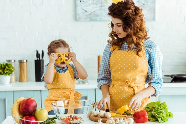 Mother Polka Dot Yellow Apron Giving Looking Daughter Bell Pepper — Stock Photo, Image