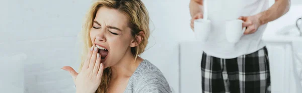 Panoramic Shot Blonde Woman Yawning Man Holding Cups Drinks — Stock Photo, Image