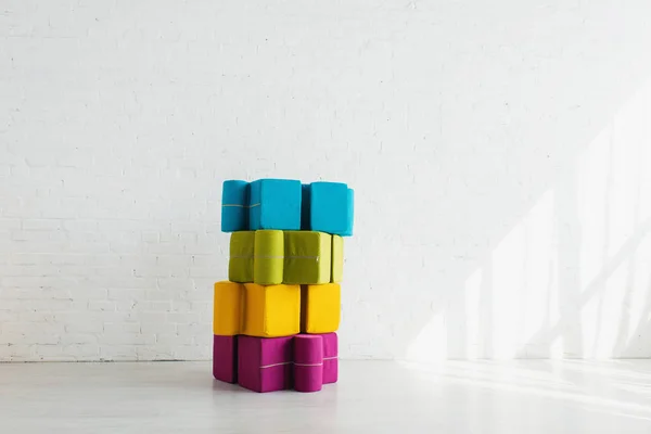 Colorful Puzzle Shape Poufs White Brick Wall Home — Stock Photo, Image