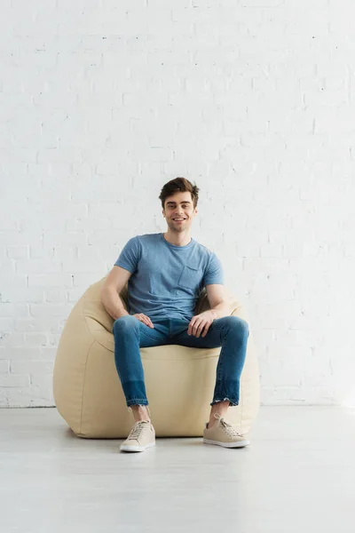 Happy Handsome Man Sitting Beige Bean Bag Chair Home — Stock Photo, Image