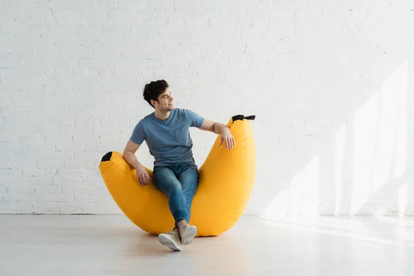 Happy Man Sitting Crossed Legs Yellow Bean Bag Chair White — Stock Photo, Image