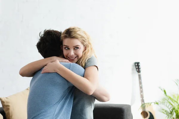 Happy Blonde Woman Smiling While Hugging Boyfriend Home — Stock Photo, Image
