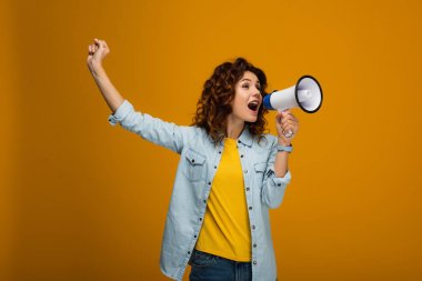 curly redhead woman screaming in megaphone and gesturing on orange  clipart