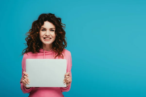 Cheerful Curly Redhead Girl Holding Laptop While Standing Blue — Stock Photo, Image