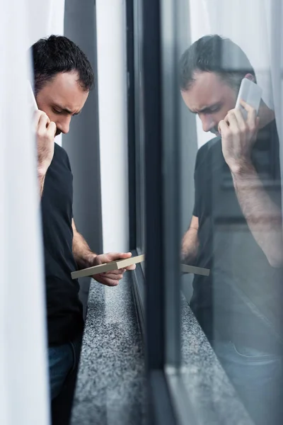 Selective Focus Upset Handsome Man Smartphone Holding Photo Frame While — Stock Photo, Image