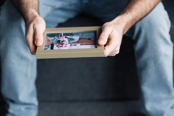 Cropped View Sitting Man Blue Jeans Holding Photo Frame — Stock Photo, Image