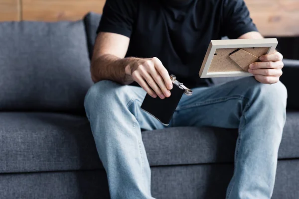 Cropped View Man Sitting Grey Sofa Holding Photo Frame Flask — Stock Photo, Image