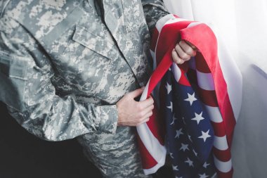 askeri üniformalı yetişkin adamın kırpılmış görünümü abd ulusal bayrağı tutan