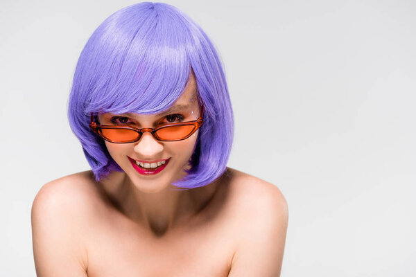 happy beautiful girl in purple wig and trendy sunglasses isolated on grey