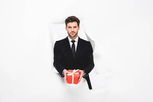 Handsome Man Suit Present Looking Camera Hole Paper White — Stock Photo, Image
