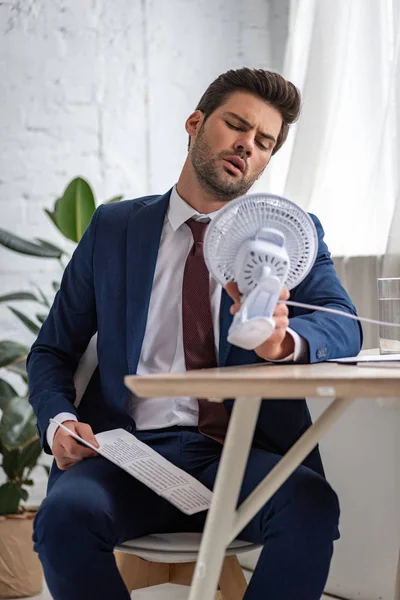 Handsome Businessman Holding Electric Fan Newspaper While Suffering Heat Office — Stock Photo, Image