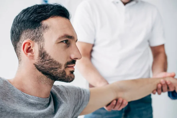 Physiotherapist Stretching Arm Good Looking Patient Hospital — Stock Photo, Image