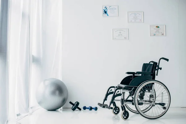 recovery room in hospital with wheelchair and sport equipment