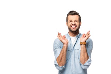 excited man with fingers crossed Isolated On White with copy space clipart