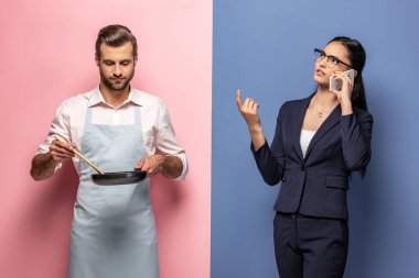 iş kadını mavi ve pembe akıllı telefon konuşurken önlük tutma tavada adam