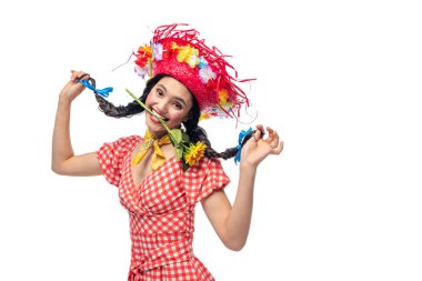 happy girl in festive clothes and Straw Hat biting sunflower Isolated On White clipart